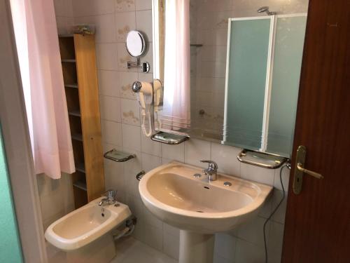 a bathroom with a sink and a mirror at Locazione Turistica F.G. Rando in Letojanni