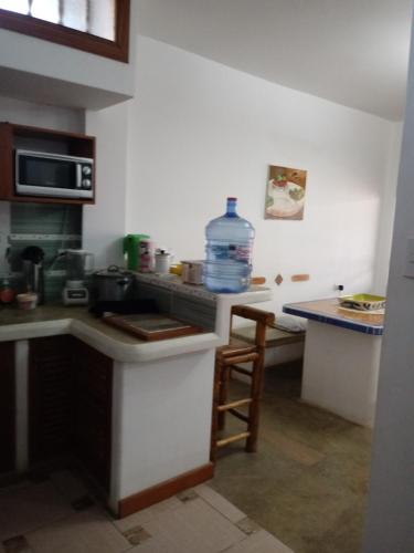 a kitchen with a sink and a counter with a water bottle at Los Pinos de Zorritos Condominio in Zorritos