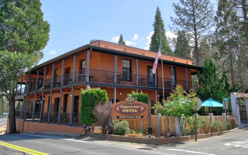an orange building with a sign in front of it at The Groveland Hotel in Groveland