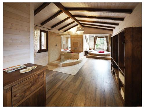 a large room with a bathroom and a bedroom at EcoResort Il Cantico della Natura in Magione