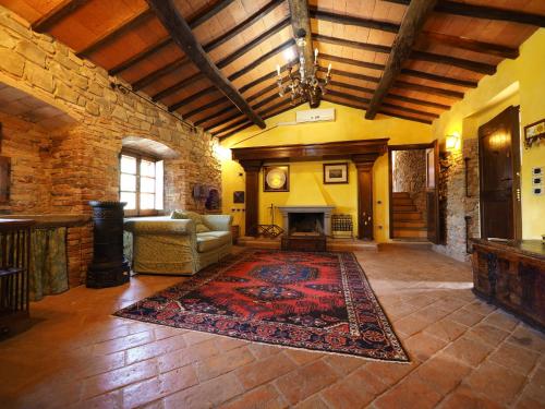 a living room with a fireplace and a rug at EcoResort Il Cantico della Natura in Magione