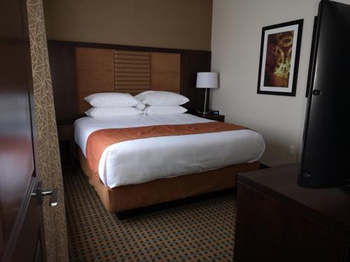 a hotel room with a large bed with white pillows at Best Western Plus Hinton Inn & Suites in Hinton
