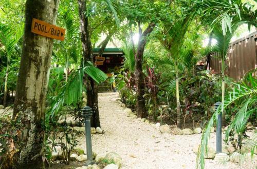 a road sign in the middle of a forest at Green Sanctuary Hotel in Nosara
