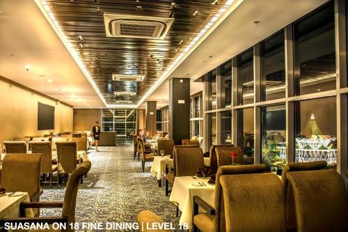 a dining room with tables and chairs in a restaurant at Astana Wing - Riverside Majestic Hotel in Kuching