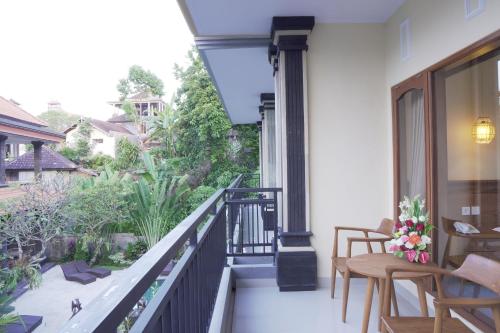 a balcony with a view of a garden at Astana House in Ubud