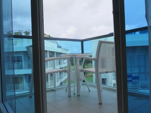 a chair and a table on a balcony at Grandblue Condominium#702 Seaview TopFloor MaePhim Rayong in Mae Pim