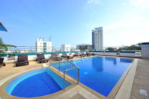 a large swimming pool on the roof of a building at Thipurai City Hotel in Hua Hin