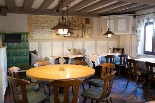 a restaurant with a wooden table and chairs at Hotel-Gasthof Weisses Ross in Schwaig bei Nürnberg