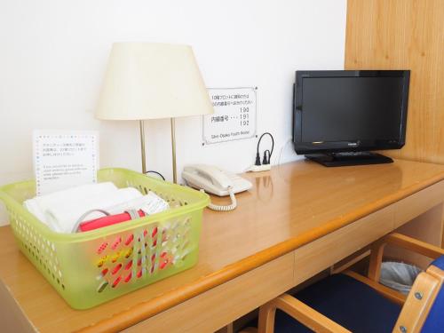 a desk with a television and a telephone on it at Shin-Osaka Youth Hostel in Osaka