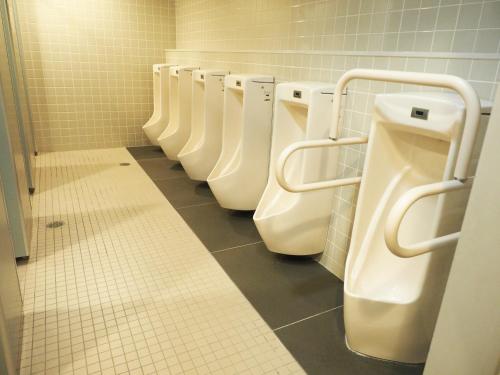 a row of urinals in a public bathroom at Shin-Osaka Youth Hostel in Osaka