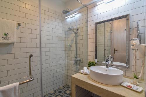 a bathroom with a sink and a shower at The Lynden Grove in Nuwara Eliya