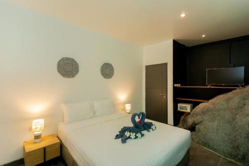 a bedroom with a bed with a ribbon on it at Baan Saint-Tropez Seaview Villas Kata Beach in Kata Beach