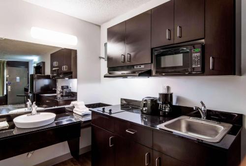 a kitchen with a sink and a microwave at Studio 6 Extended Stay - Lagrange, GA in La Grange