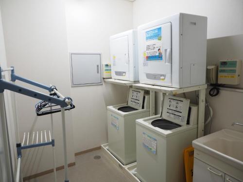 a laboratory with three machines in a room at Shin-Osaka Youth Hostel in Osaka