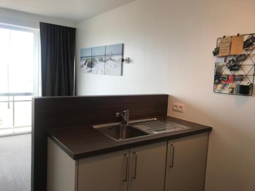 a kitchen with a sink and a counter top at 50 Zeedijk in De Panne