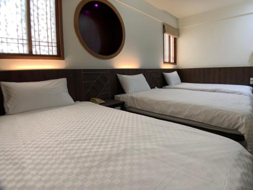 Postel nebo postele na pokoji v ubytování Penghu An-I Hotel