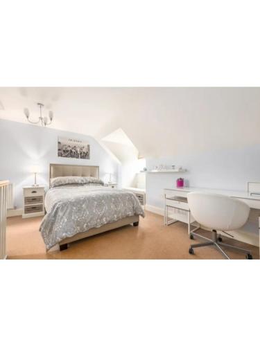 a bedroom with a bed and a desk and a chair at 9 College Court Spacious, Modern 4-Bed Townhouse in York - Pass the Keys in York