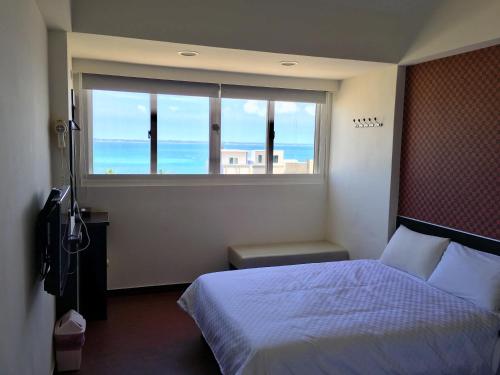 Postel nebo postele na pokoji v ubytování Penghu An-I Hotel