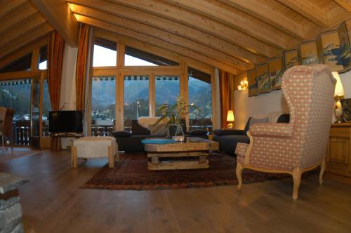 a living room with a couch and a table at Chalet Guggenbiel in Zermatt