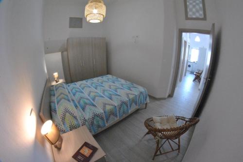 a bedroom with a bed and a table and a mirror at Fronte mare siculiana marina in Siculiana Marina