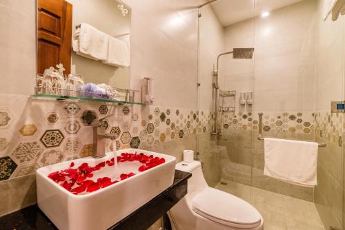een badkamer met een wastafel, een toilet en een douche bij Phong Phu Villa Hoi An in Hội An