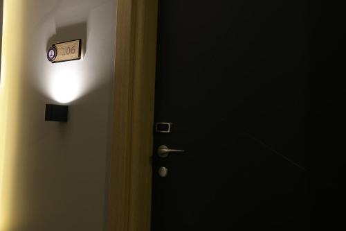 a door with a clock on the side of it at Burhaniye Marina Boutique Hotel in Burhaniye