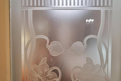 a window with a curtain with flowers on it at Leuhusen Collection Vienna, Wien in Vienna