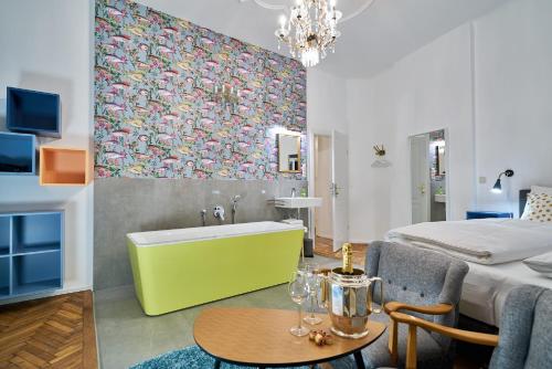 a living room with a bed and a tub in a room at Leuhusen Collection Vienna, Wien in Vienna