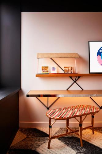 a desk with a bench and a shelf at Mama Shelter Toulouse in Toulouse