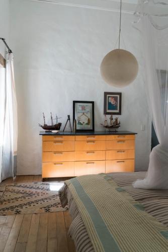 a bedroom with a dresser and a bed in it at Kleinkloof Farm in Piketberg