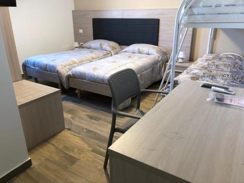 a room with two beds and a bunk bed at La punta dei venti in Pellaro