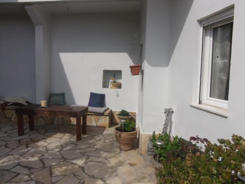 a room with a table and a bench and a window at Village House in Liapades