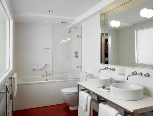 a bathroom with a sink, toilet and bathtub at The Bull and Townhouse - Beaumaris in Beaumaris