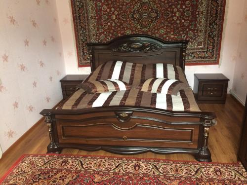 a bed in a bedroom with a rug on the floor at Gokor B&B in Dilijan