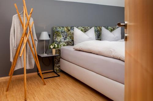 a bedroom with a bed with white pillows at Fügenschuh's Ferienwohnungen in Bad Hindelang