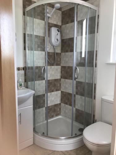 a shower stall in a bathroom with a toilet at 24 Elmhurst Road in Lytham St Annes