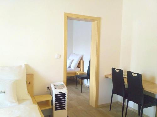 a room with a bed and a table and chairs at Rodinný wellness hotel U Langrů in Dolní Věstonice