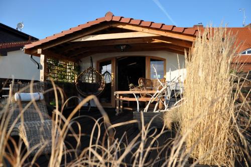 a house with a porch with a table and chairs at Normandia in Kuźnica