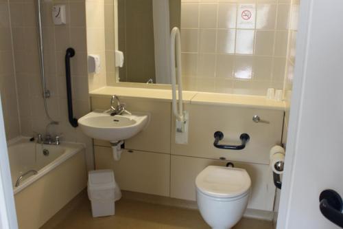 a bathroom with a toilet and a sink at Redwings Lodge Baldock in Baldock