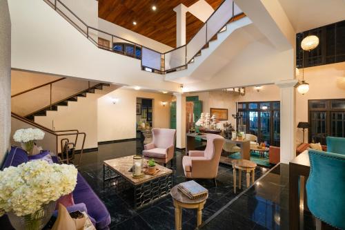 a living room with purple furniture and a staircase at Clove Villa in Kandy