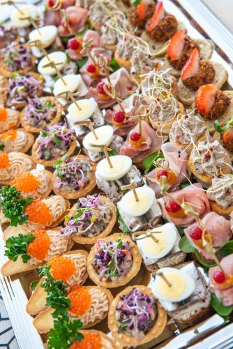 a display of appetizers and snacks on a tray at Roosta Holiday Village in Elbiku