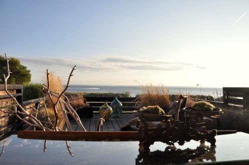a view of the ocean from a table with some plants at Normandia in Kuźnica