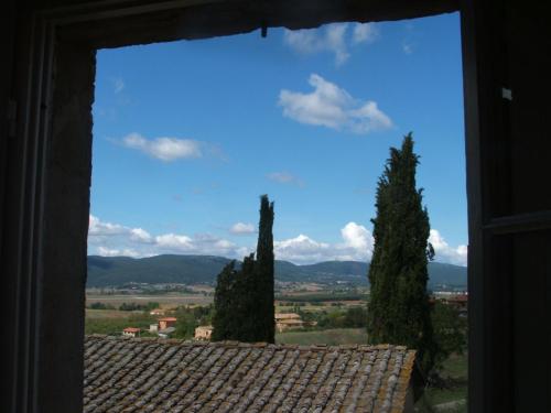 a window with a view of trees and a sky at Fattoria Di Cavaglioni in San Rocco a Pilli