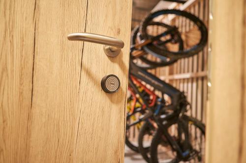 a wooden door with a knob on it with at AlpenParks Hotel & Apartment Sonnleiten in Saalbach Hinterglemm