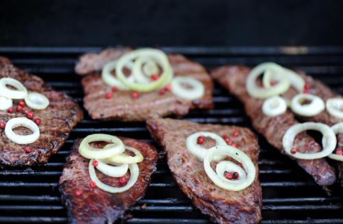 a bunch of food cooking on a grill at Roosta Holiday Village in Elbiku