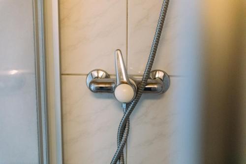 a door knob on a door with a chain at Hotel - Restaurant Waage in Bremgarten