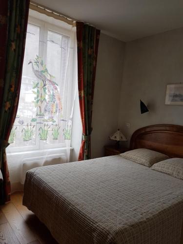 a bedroom with a bed and a window at Appartement Cap Horn in Le Mont-Dore