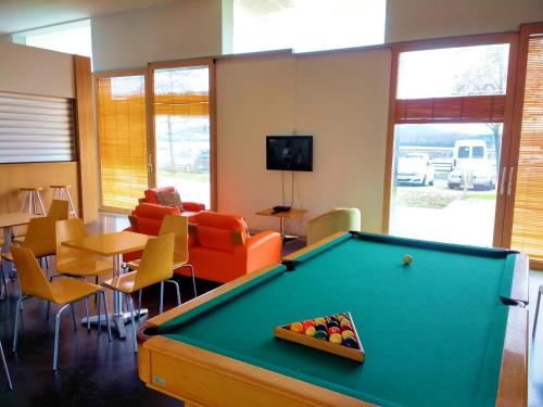 a billiard room with a pool table and chairs at HI Viana do Castelo - Pousada de Juventude in Viana do Castelo