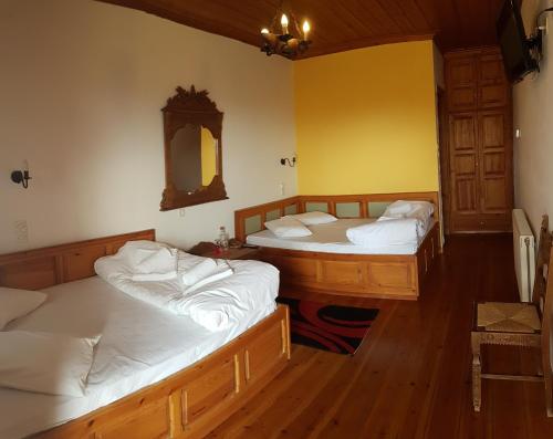a room with three beds and a mirror at Kalliopi in Papingo