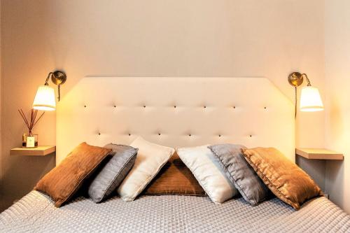 a bedroom with a bed with pillows on it at La Colonna (Historic Centre) in Lucca